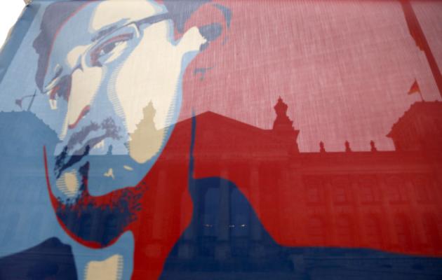 Reichstag pictured though flag depicting fugitive former U.S. NSA contractor Snowden in Berlin