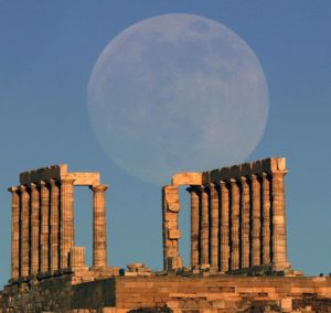 The moon rises over the temple of Poseidon in Cape Sounion east of Athens